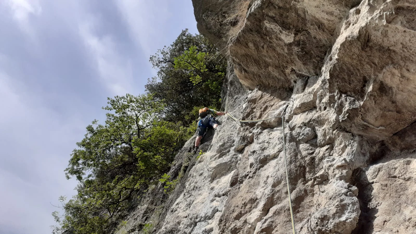 Eine Person klettert mit Seil an einer senkrechten Felswand unter blauem Himmel. | © DAV Dortmund