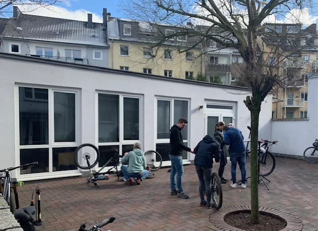 Mehrere Personen reparieren Fahrräder im Innenhof eines Gebäudes. | © DAV Dortmund