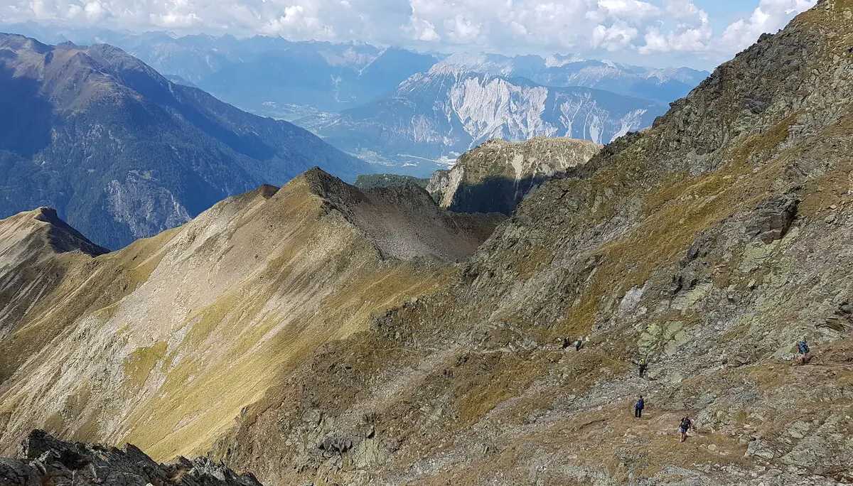 Aussicht über ein weites, felsiges Hochtal mit mehreren Bergketten im Hintergrund. | © DAV Dortmund