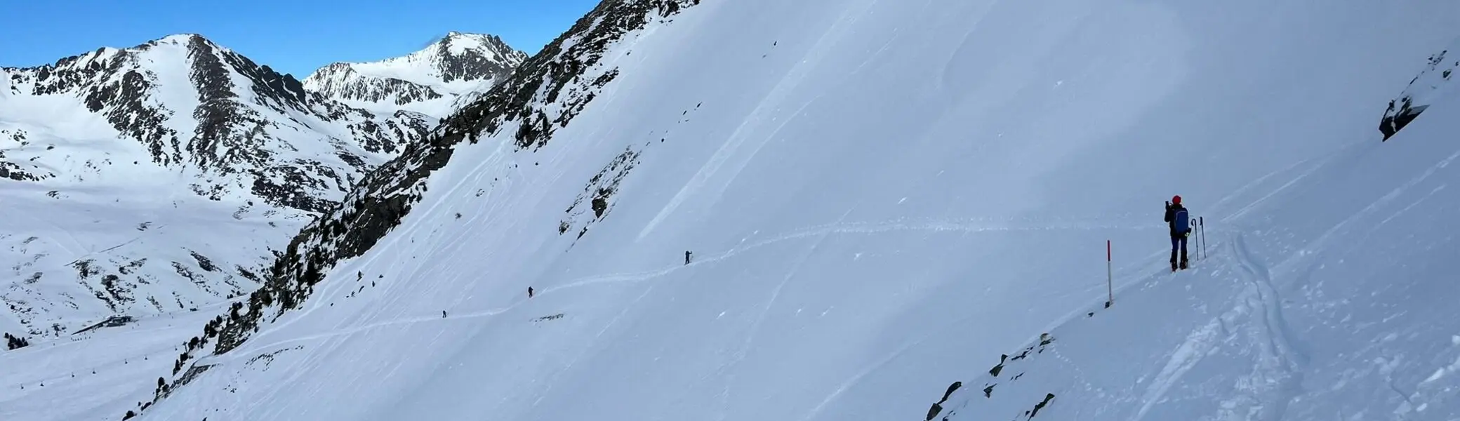 Zwei Tourengeher*innen queren einen verschneiten Hang im Hochgebirge. | © DAV Dortmund