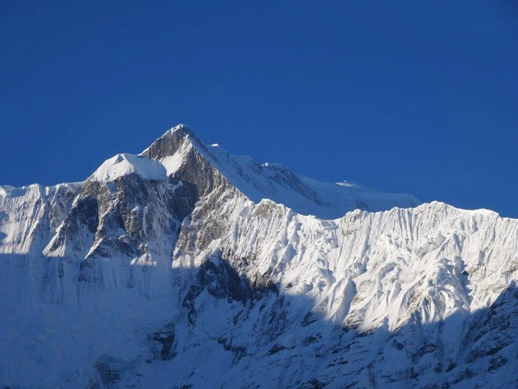 Schneebedeckter Berggipfel im Sonnenlicht mit scharfen Konturen und blauem Himmel. | © DAV Dortmund