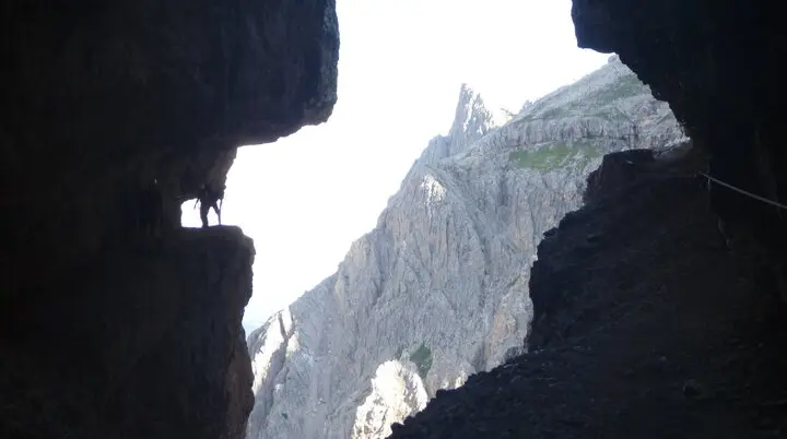 Blick aus einer Felsspalte auf einen spitzen Berggipfel im Hintergrund. | © DAV Dortmund