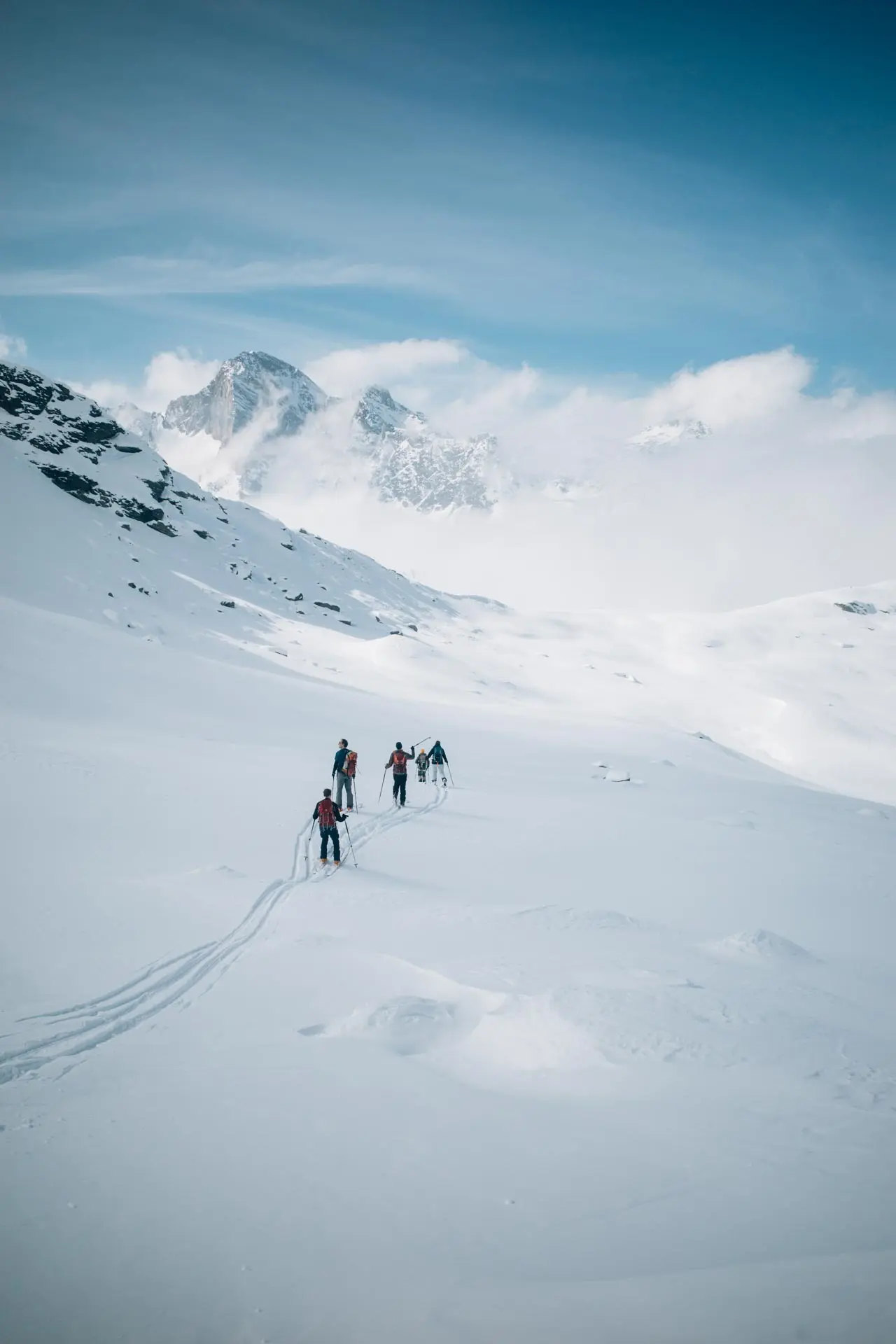 5 Skitourengeher in einem weiten Tal | © Tim Hilbrand